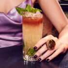 Woman holding rum QPS cocktail